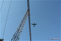 Plane landing above Yeager's approach light bridge in Coonskin Park