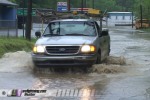 Truck drives on flooded road