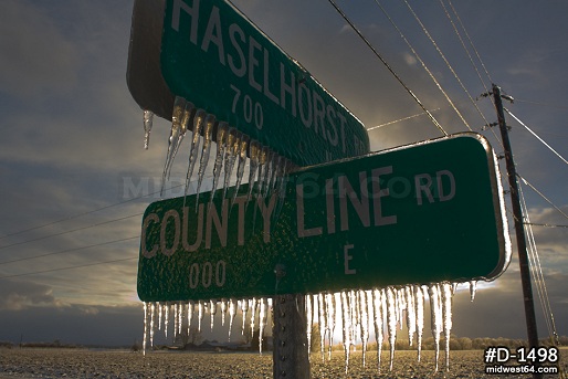 Sunlit ice storm icing on signs in in Clinton County, IL