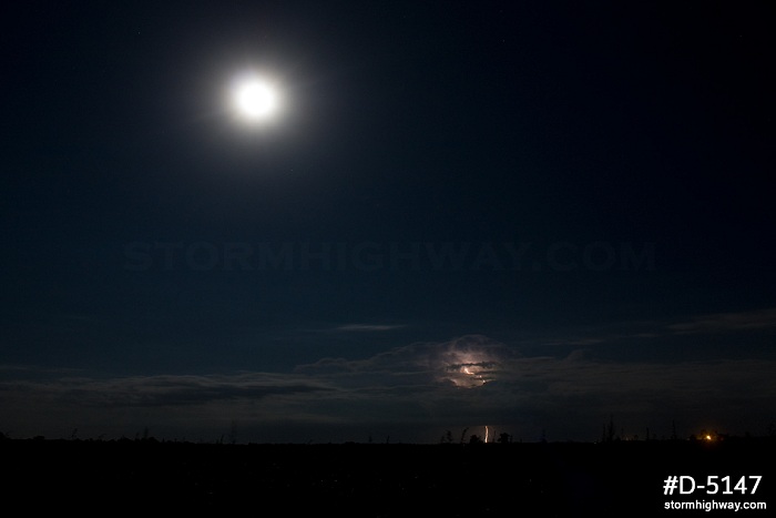 Distant storm, lightning and full moon