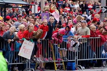 young fans eagerly await the parade