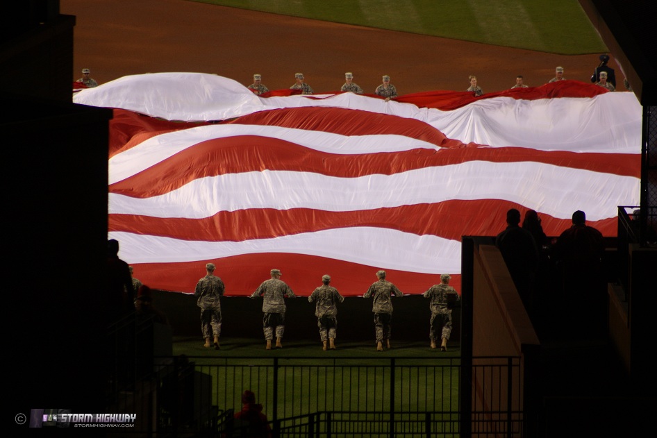 Rolling out the giant American Flag over the field