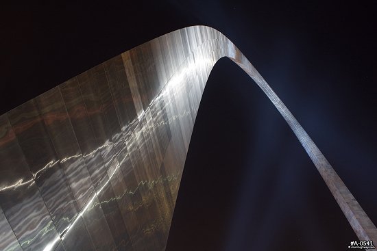 Gateway Arch at night, illuminated with spotlights