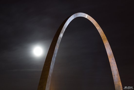 Gateway Arch at night with a bright moon