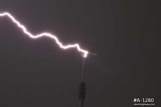 Close-up of lightning striking tower antenna