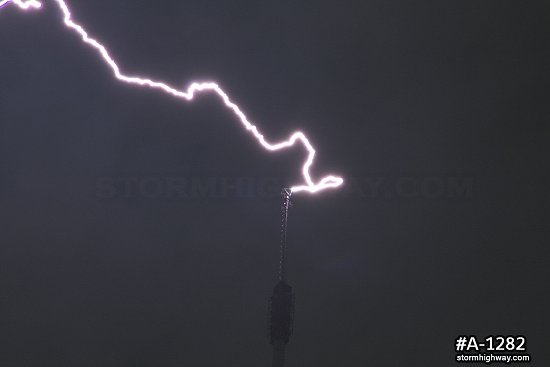 Close-up of lightning striking tower antenna