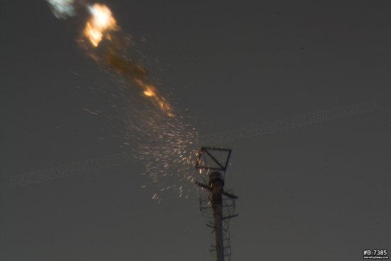An explosion of sparks and smoke as lightning has just struck the top of a television tower in this extreme close-up view.
