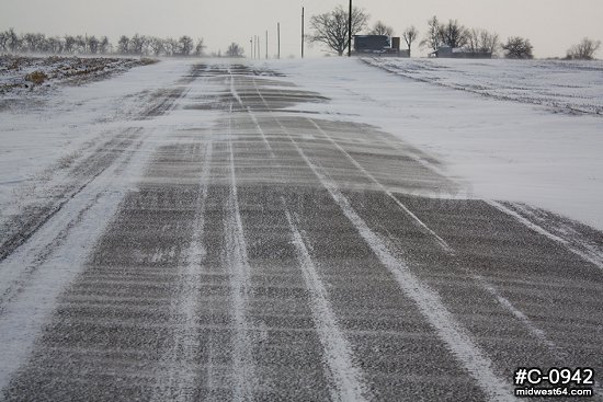 Illinois prairie road blowing snow scene