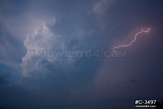 Lightning illuminates a storm at dusk near Woodward, OK