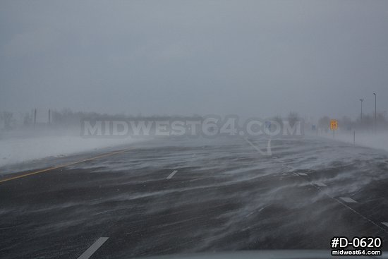Blowing snow crossing an interstate highway.