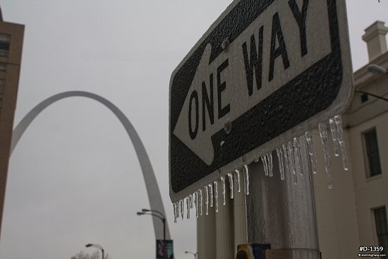 Icicles on a street sign in front of the Gateway Arch in St. Louis