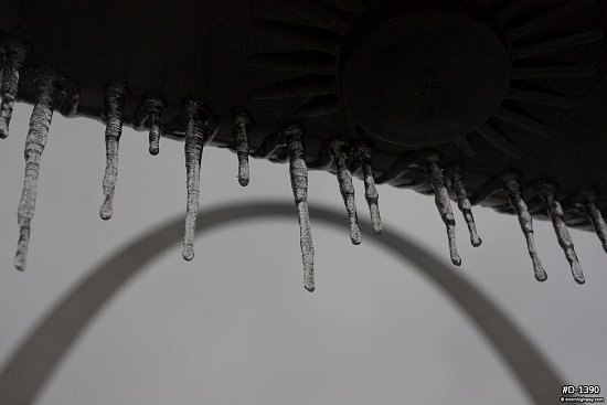 Icicles on a traffic signal in front of the Gateway Arch in St. Louis