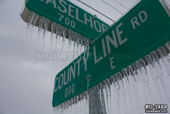 Thick icicles on street signs after an ice storm