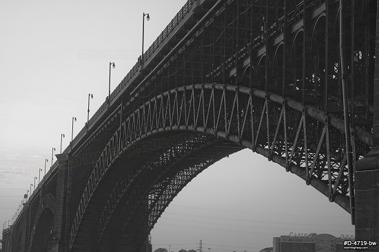 Sunrise glow on the Eads Bridge over the Mississippi River in St. Louis, black and white