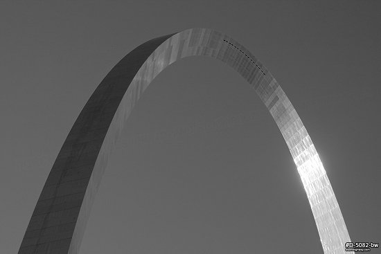 Blue sky and sunlight reflecting in the Gateway Arch, black and white