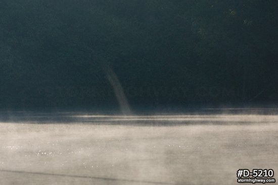 Steam devil vortex on a foggy lake surface