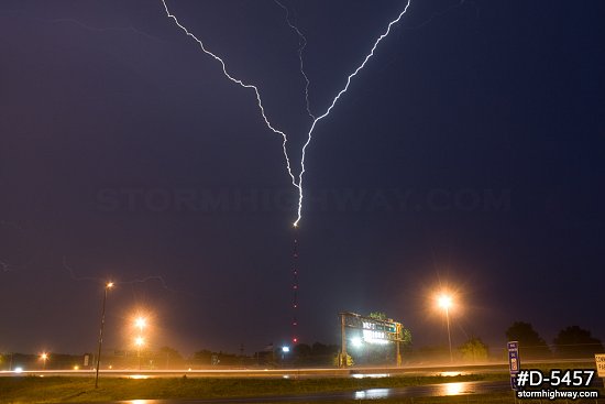 Upward lightning strikes a TV tower at night 
