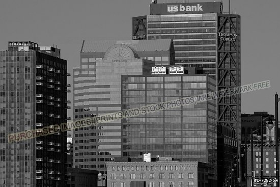 Downtown buildings in early morning sunlight with blue sky, black and white