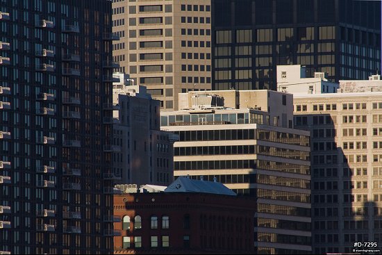Tight zoom on a cluster of downtown buildings in morning sunlight