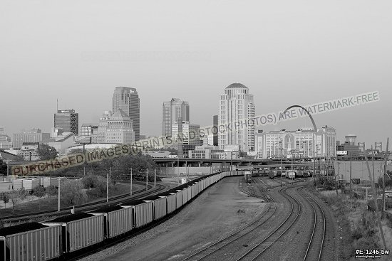 Belt of Venus accents the St. Louis skyline over railroad tracks leading into the city, black and white