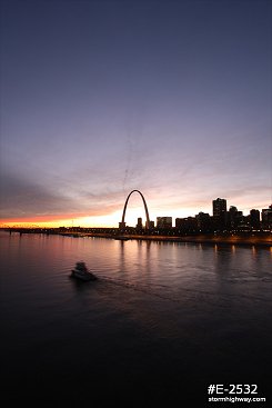 Vivid Sunset over St. Louis with river tugboat