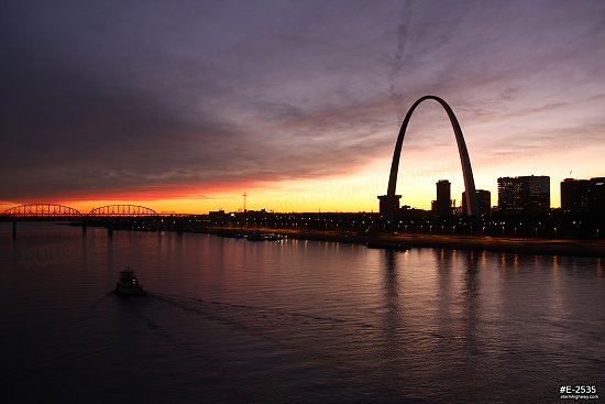 Vivid Sunset over St. Louis with river tugboat