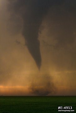 Tornado with debris over the prairie at sunset near Rozel, Kansas