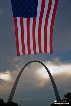 Large American flag over the Gateway Arch in St. Louis.