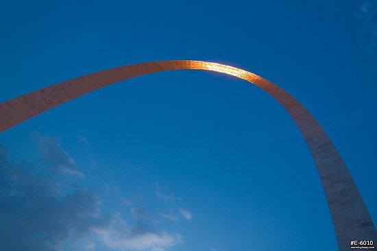 Blue sky and orange setting sunlight reflecting in the Gateway Arch