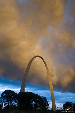 Sunset-illuminated storm clouds over the St. Louis Gateway Arch, vertical view