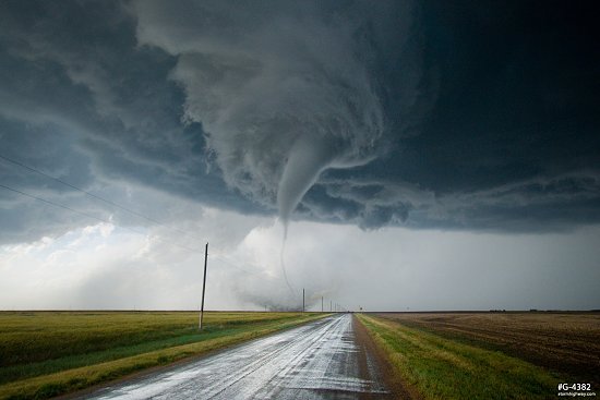Contorted tornado strengthens and its funnel condenses downward near Dodge City, Kansas