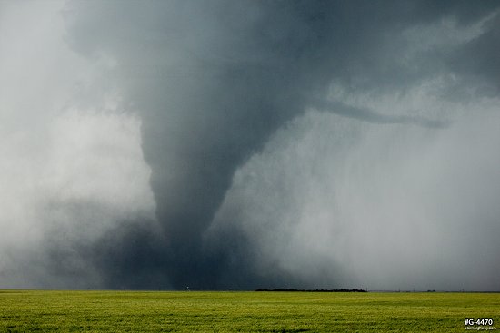 Contorted strong tornado with a horizontal vortex and large debris cloud near Dodge City, Kansas