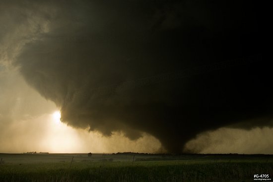 The sun shines through the parent storm's RFD clear slot as a violent EF4 tornado moves near Abilene, Kansas