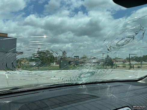 Broken windshield from softball-sized hail