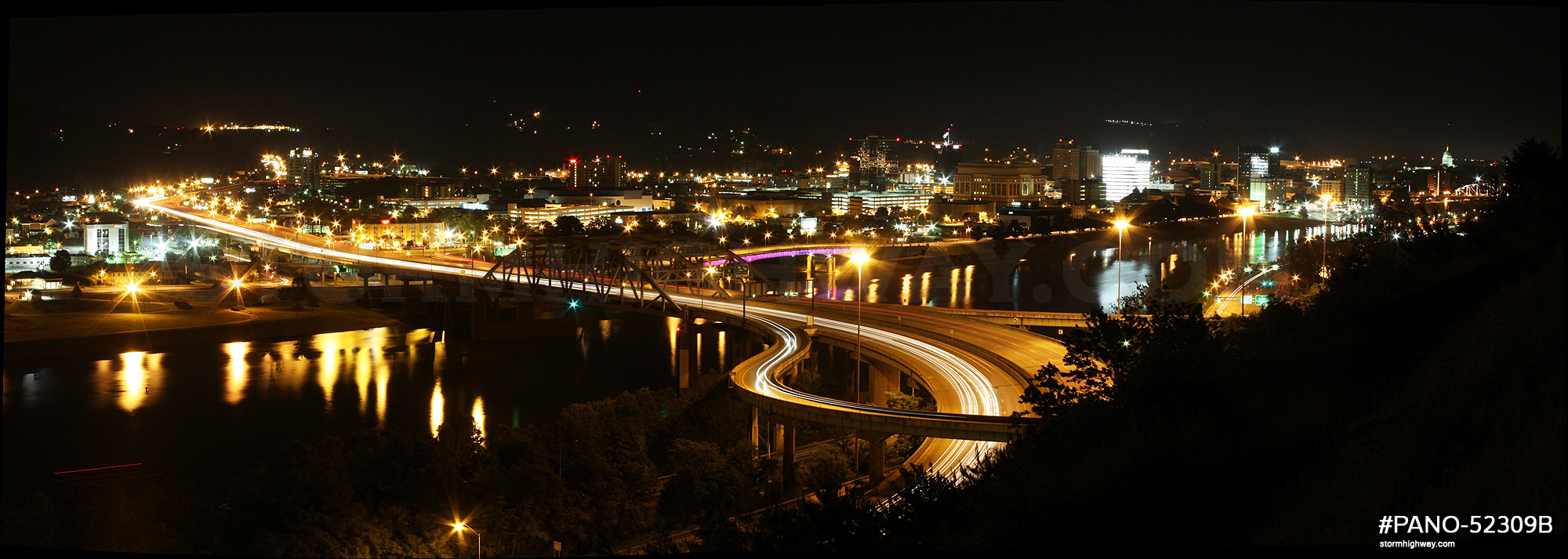 Panoramic image of Fort Hill Bridge and downtown Charleston at night