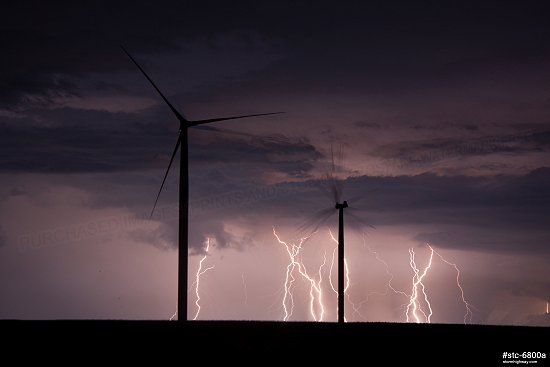 Lightning behind wind turbines in central Illinois at night