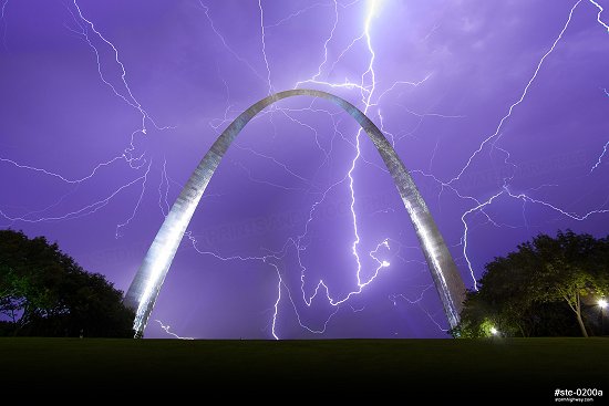 Lightning filling the sky over the Gateway Arch at night