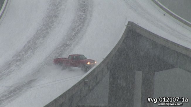 Pickup truck hits barrier in accident on snowy interstate