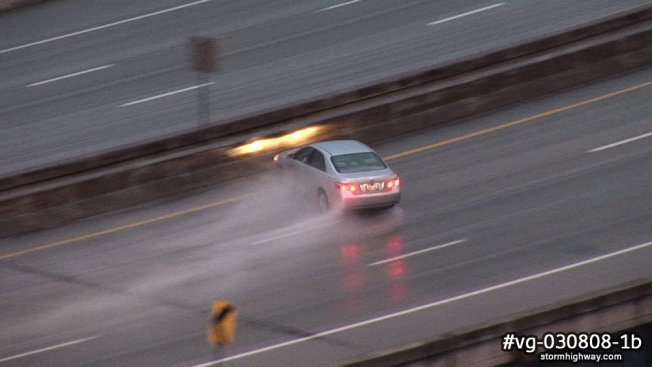 Car loses control and spins out on a freezing rain and sleet covered interstate bridge